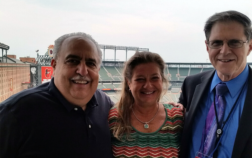 Photo of 3 employees at a baseball stadium